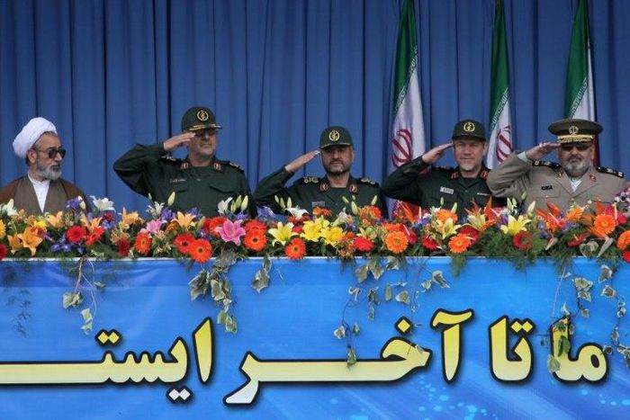 A clergyman looks towards top Iranian military commanders including (L) Mohammad Pakpour, head of ground forces of the Revolutionary Guards, during the Army Day parade in Tehran on April 18, 2010