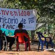 Members of the FARC leftist guerrilla rest at the entrance to the area where the rebels are gathering in the municipality of San Jose de Oriente, Cesar department, northern Colombia on February 28, 2017
