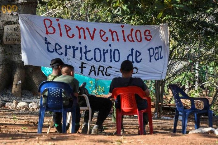 Members of the FARC leftist guerrilla rest at the entrance to the area where the rebels are gathering in the municipality of San Jose de Oriente, Cesar department, northern Colombia on February 28, 2017