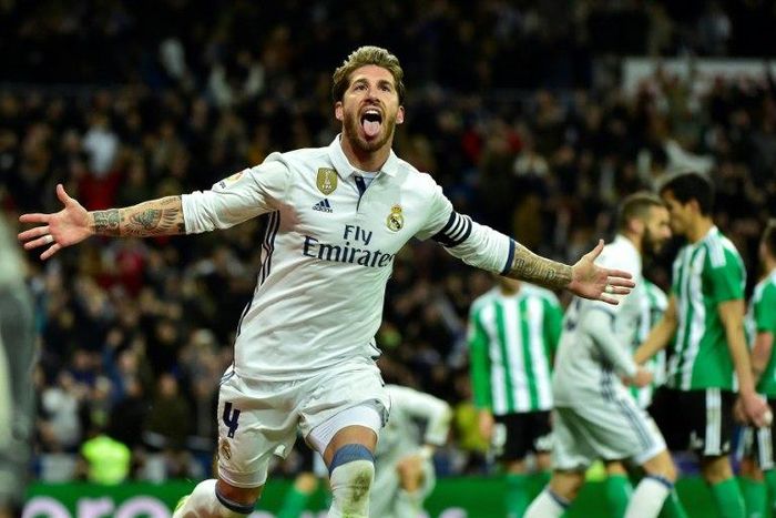 Real Madrid's defender Sergio Ramos celebrates after scoring a goal during the Spanish league footbal match Real Madrid CF vs Real Betis at the Santiago Bernabeu stadium in Madrid on March 12, 2017