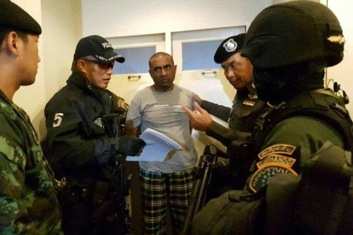 Pakistani national Abdul Rehman (C), was arrested in Bangkok and is suspected of being part of an extortion gang that burned down a Karachi factory in 2012 killing 259