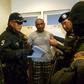 Pakistani national Abdul Rehman (C), was arrested in Bangkok and is suspected of being part of an extortion gang that burned down a Karachi factory in 2012 killing 259