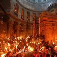 Christian Orthodox worshippers hold candles during the ceremony of the "Holy Fire" in the Church of the Holy Sepulchre in Jerusalem's Old City on April 15, 2017