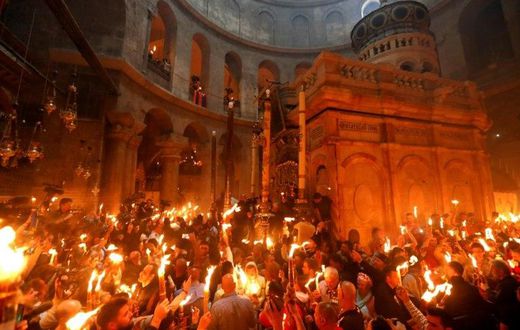 Christian Orthodox worshippers hold candles during the ceremony of the "Holy Fire" in the Church of the Holy Sepulchre in Jerusalem's Old City on April 15, 2017