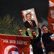 A supporter of the "Yes" campaign holds up a picture of Turkish president Recep Tayyip Erdogan during a rally near the headquarters of the conservative Justice and Development Party (AKP) in Istanbul on April 16, 2017 after initial results