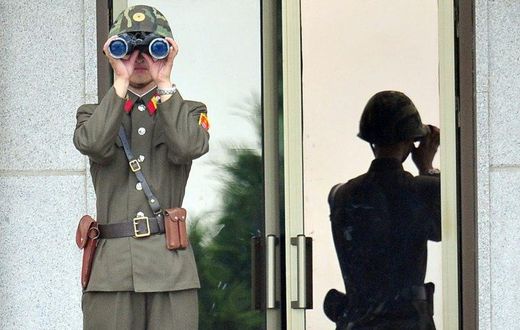 A North Korean soldier looks at the South side at the truce village of Panmunjom in the Demilitarized zone (DMZ) dividing the two Koreas on July 27, 2013