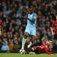 Manchester City's Yaya Toure (CL) vies with Manchester United's Henrikh Mkhitaryan during their English Premier League football match at the Etihad Stadium in Manchester, north west England, on April 27, 2017
