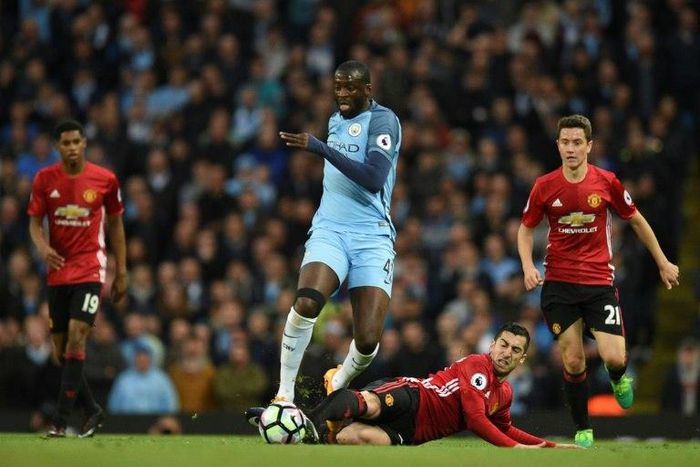 Manchester City's Yaya Toure (CL) vies with Manchester United's Henrikh Mkhitaryan during their English Premier League football match at the Etihad Stadium in Manchester, north west England, on April 27, 2017