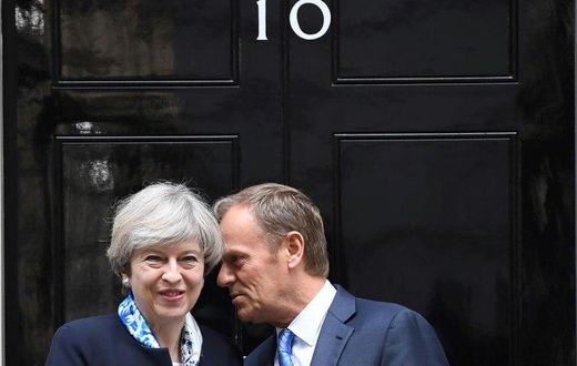 EU President Donald Tusk (R) said that before talks with Britain over Brexit "we must first sort out our past" and resolve the key divorce issues of "people, money and Ireland"