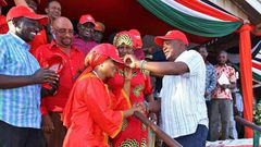 President Uhuru Kenyatta receives defectors during a public rally at Voi Stadium. Looking on is Dr Naomi Shaban.