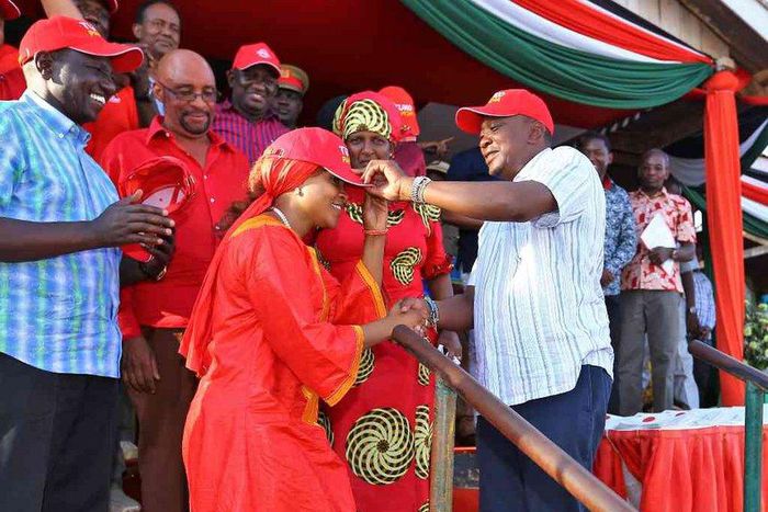 President Uhuru Kenyatta receives defectors during a public rally at Voi Stadium. Looking on is Dr Naomi Shaban.