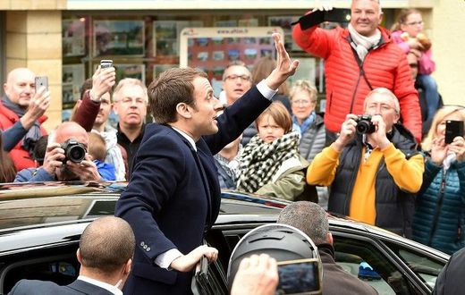 French centrist presidential candidate Emmanuel Macron greets supporters as France votes in the first round of an unpredictable election