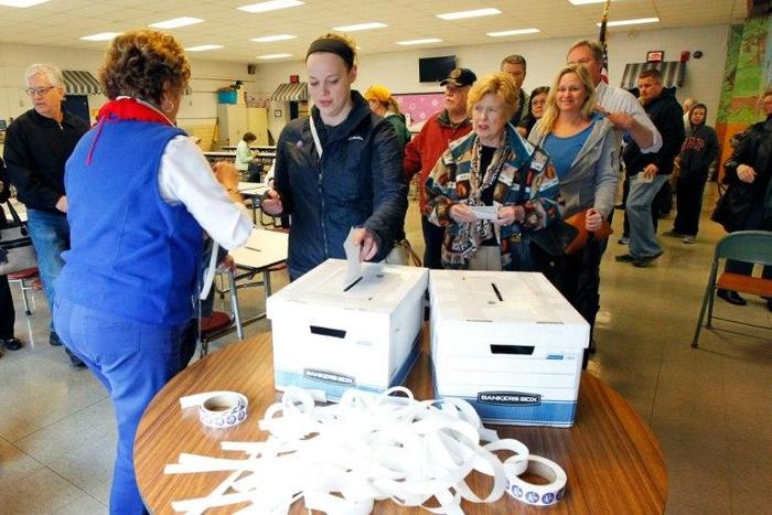 Kentucky voters place their paper ballots in the box in a GOP presidential caucus on March 5, 2016, in Louisville, Kentucky