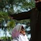 A religious officer canes a woman for spending time in close proximity with a man who is not her husband in Banda Aceh, Indonesia, on November 28, 2016