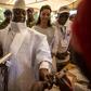 Incumbent Gambian President Yahya Jammeh (C) has his finger inked before casting his marble in a polling station in Banjul on December 01, 2016