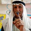 A Palestinian man shows his ink-stained finger after casting his ballot during municipal elections in the village of Yatta in the West Bank on May 13, 2017
