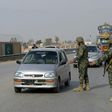 Pakistani paramilitary soldiers stop a vehicle at a security check point in Peshawar on February 17, 2017