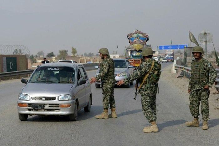 Pakistani paramilitary soldiers stop a vehicle at a security check point in Peshawar on February 17, 2017