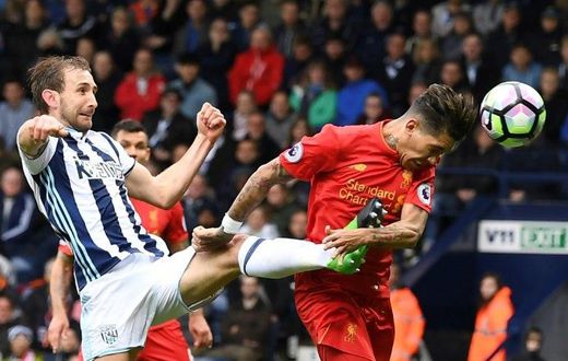 Liverpool's Roberto Firmino heads the opening goal past West Bromwich Albion's Craig Dawson during the English Premier League match at The Hawthorns in West Bromwich, central England, on April 16, 2017