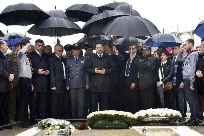 Lebanese Prime Minister Saad Hariri (C) prays over the tomb of his father, slain former prime minister Rafiq Hariri, in Beirut on February 14, 2017