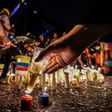 Opposition activists place candles to protest against the deaths of 43 people in clashes with the police during weeks of anti-government demonstrations