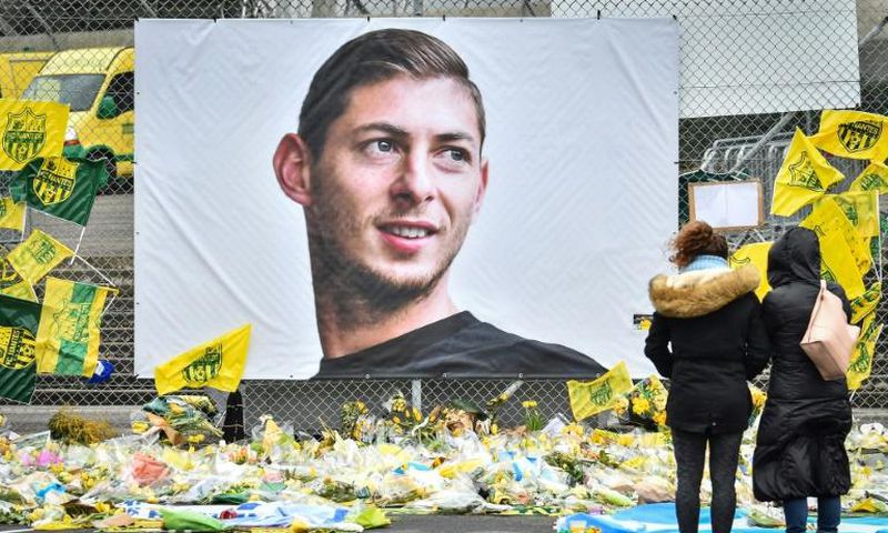 Mourners left yellow flowers below the portrait of Argentine football forward Emiliano Sala at the Beauvoir stadium in Nantes following his death in January 2019