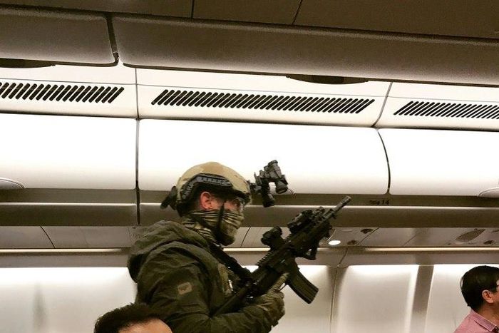 Armed police boarded a Malaysia Airlines flight which was forced to return to Melbourne after a passenger tried to enter the cockpit claiming he had a bomb