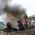 A member of the Syrian civil defence tries to extinguish fire from a burning vehicle following a reported car bomb explosion in the rebel-held town of Azaz in northern Syria on May 3, 2017