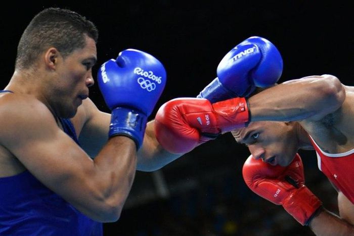 France's Tony Yoka (red) fights against Britain's Joe Joyce (blue) in the men's super heavy (+91kg) final bout at the Rio Games on August 21, 2016