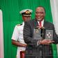 President Uhuru Kenyatta displays a set of the new currency Kenyan coins during their launch in December 2018 (PSCU)