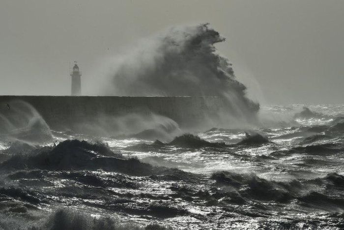 Waves crash over Newhaven Lighthouse on the south coast of England on February 23, 2017 as Storm Doris hits the country