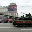 People watch as pro-Russian rebels parade tanks through the center of Donetsk during a WWII Victory Day parade, on May 9, 2017