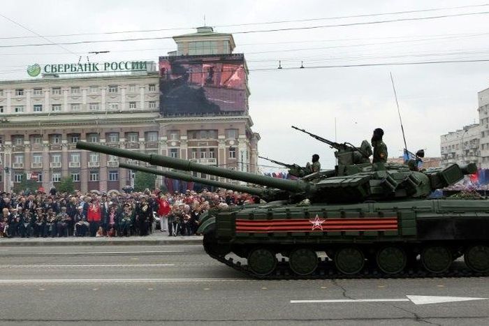 People watch as pro-Russian rebels parade tanks through the center of Donetsk during a WWII Victory Day parade, on May 9, 2017