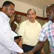 Mombasa Senator Hassan Omar shakes hands with Nyali MP Hezron Awiti as Jubilee's Suleiman Shahbal looks on at an earlier event.