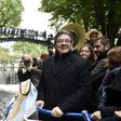 French presidential election candidate for the far-left coalition La France insoumise Jean-Luc Melenchon (L), stands aboard an "unbowed" barge on the Canal Saint-Martin on April 17, 2017 in Paris