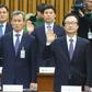 National Security Office chief Kim Kwan-Jin (L) and other presidential aides take an oath during a hearing on South Korean President Park Geun-Hye's corruption scandal in Seoul