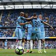 Manchester City's Nicolas Otamendi (2R) is mobbed by teammates as they celebrate scoring his team's fifth goal during their Premier League match against Crystal Palace at the Etihad Stadium in Manchester on May 6, 2017