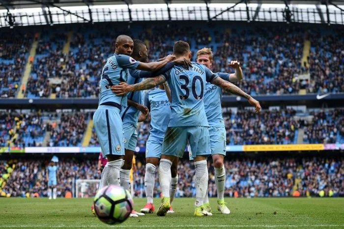 Manchester City's Nicolas Otamendi (2R) is mobbed by teammates as they celebrate scoring his team's fifth goal during their Premier League match against Crystal Palace at the Etihad Stadium in Manchester on May 6, 2017
