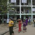 People leave a polling station after casting their votes in Myanmar by-elections, seen as a barometer for growing disillusionment in the country