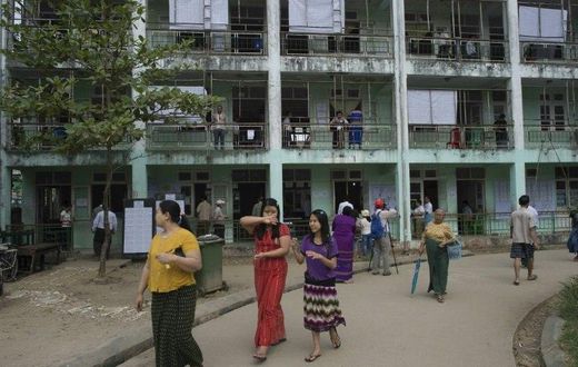 People leave a polling station after casting their votes in Myanmar by-elections, seen as a barometer for growing disillusionment in the country