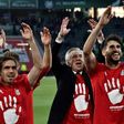 L-R: Bayern Munich's defender Philipp Lahm, head coach Carlo Ancelotti and midfielder Javier Martinez celebrate after winning the German Bundesliga title on April 29, 2017