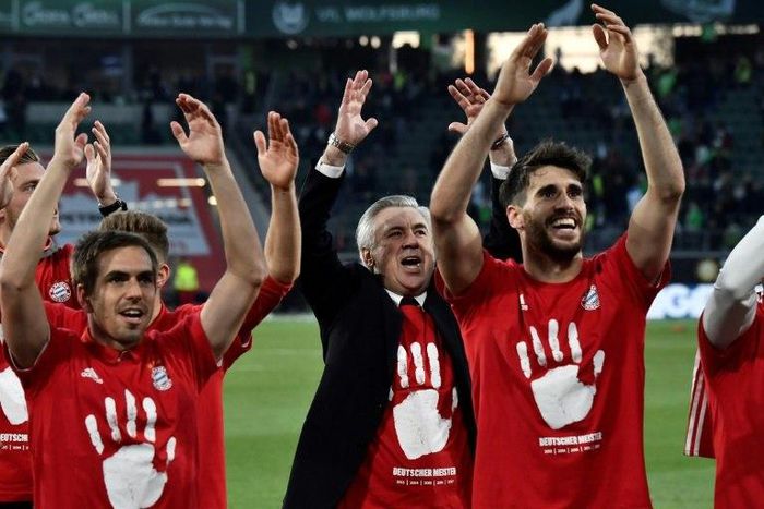 L-R: Bayern Munich's defender Philipp Lahm, head coach Carlo Ancelotti and midfielder Javier Martinez celebrate after winning the German Bundesliga title on April 29, 2017