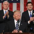 US Vice President Mike Pence (left) and House of Representatives Speaker Paul Ryan (right) applaud as President Donald Trump delivers his first address to a joint session of Congress