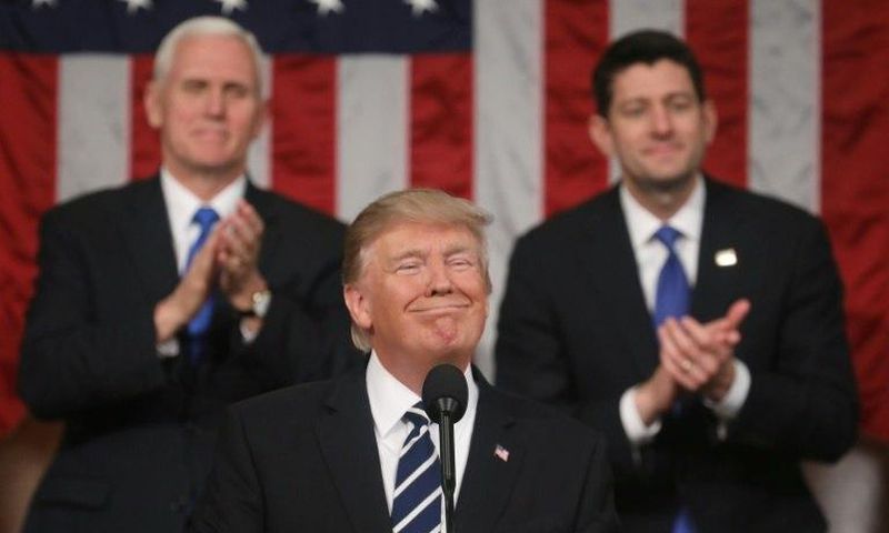 US Vice President Mike Pence (left) and House of Representatives Speaker Paul Ryan (right) applaud as President Donald Trump delivers his first address to a joint session of Congress