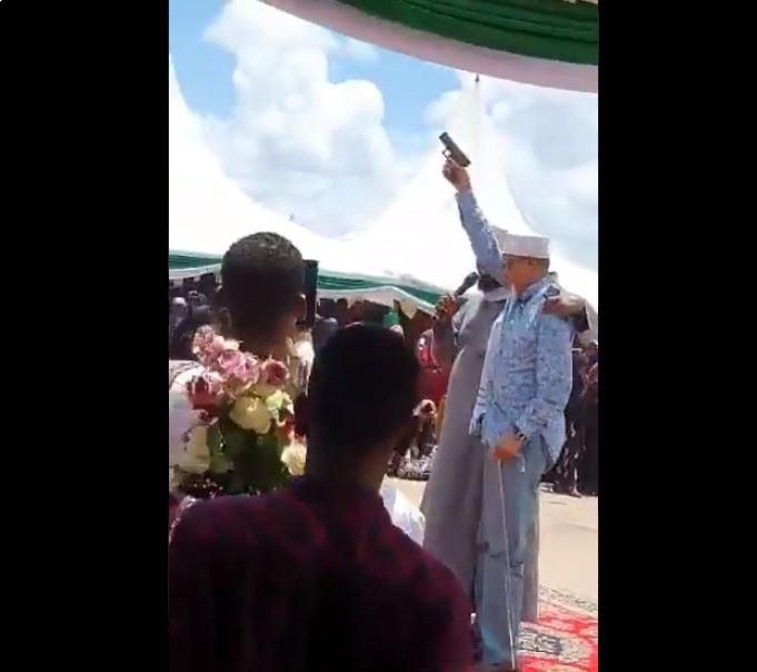 Man said to be Senator Yussuf Haji brandishing a pistol during a public function (Twitter)