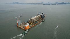 The lifting ship carrying the wreck was escorted by a smaller boat carrying relatives of the nine missing, as well as other patrol craft