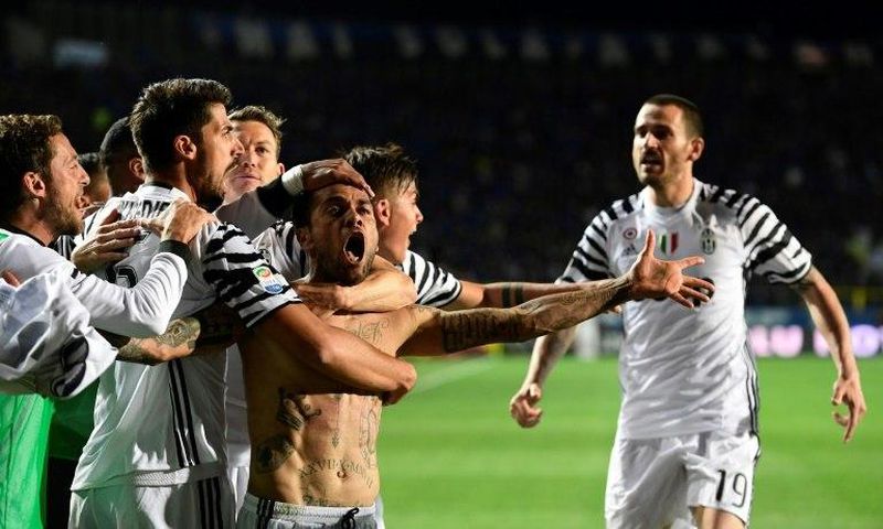 Juventus' defender Daniel Alvez da Silva celebrates with teammates after scoring during the Italian Serie A football match against Atalanta on April 28, 2017