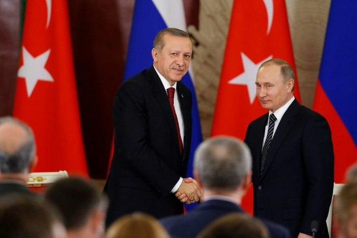 Russian President Vladimir Putin (R) and Turkey's President Recep Tayyip Erdogan shake hands after a joint news conference following their talks at the Kremlin in Moscow on March 10, 2017