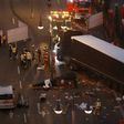 Forensic experts examine the scene around a truck that crashed into a Christmas market on December 20, 2016 in Berlin