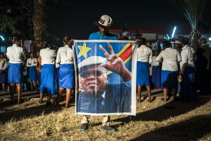 A supporter of the Democratic Republic of Congo's opposition leader Etienne Tshiskedi holds his portrait during a rally in Kinshasa in 2016